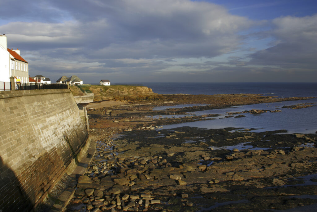 England, Tyne and Wear, Cullercoats. A sea wall built to defend the North Tyneside village of Cullercoats from the forces of the North Sea.