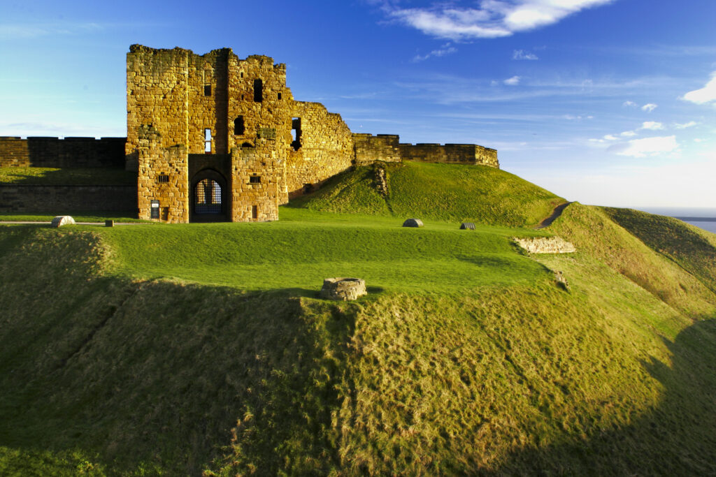 ENGLAND, Tyne and Wear, Tynemouth Castle and Priory. The setting sun iluminates the ruins of the castle and priory (english heritage)