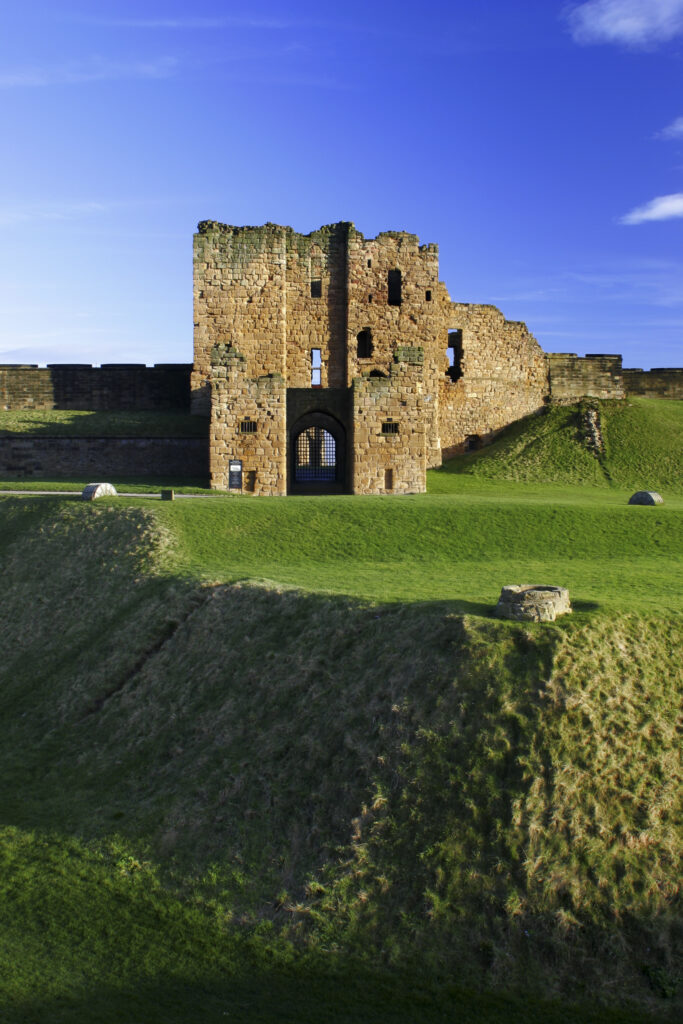 ENGLAND, Tyne and Wear, Tynemouth Castle and Priory. The setting sun iluminates the ruins of the castle and priory (english heritage)