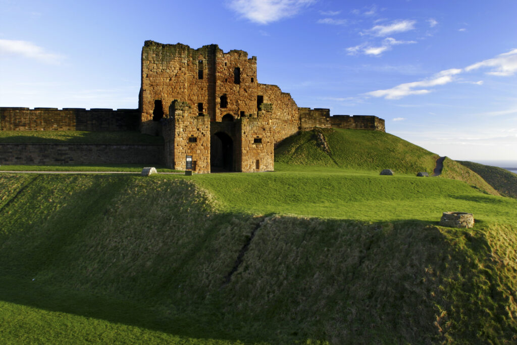 ENGLAND, Tyne and Wear, Tynemouth Castle and Priory. The setting sun iluminates the ruins of the castle and priory (english heritage)
