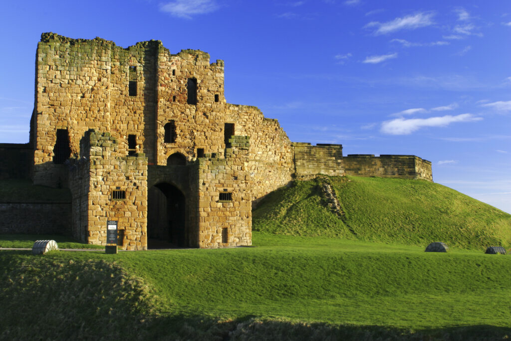 ENGLAND, Tyne and Wear, Tynemouth Castle and Priory. The setting sun iluminates the ruins of the castle and priory (english heritage)
