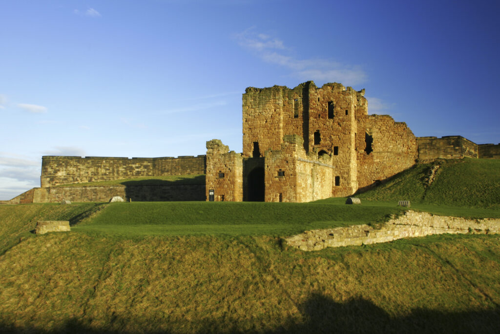 ENGLAND, Tyne and Wear, Tynemouth Castle and Priory. The setting sun iluminates the ruins of the castle and priory (english heritage)