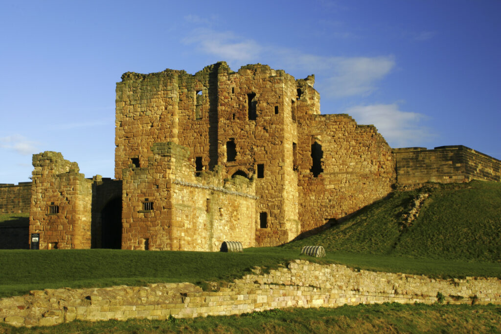 ENGLAND, Tyne and Wear, Tynemouth Castle and Priory. The setting sun iluminates the ruins of the castle and priory (english heritage)