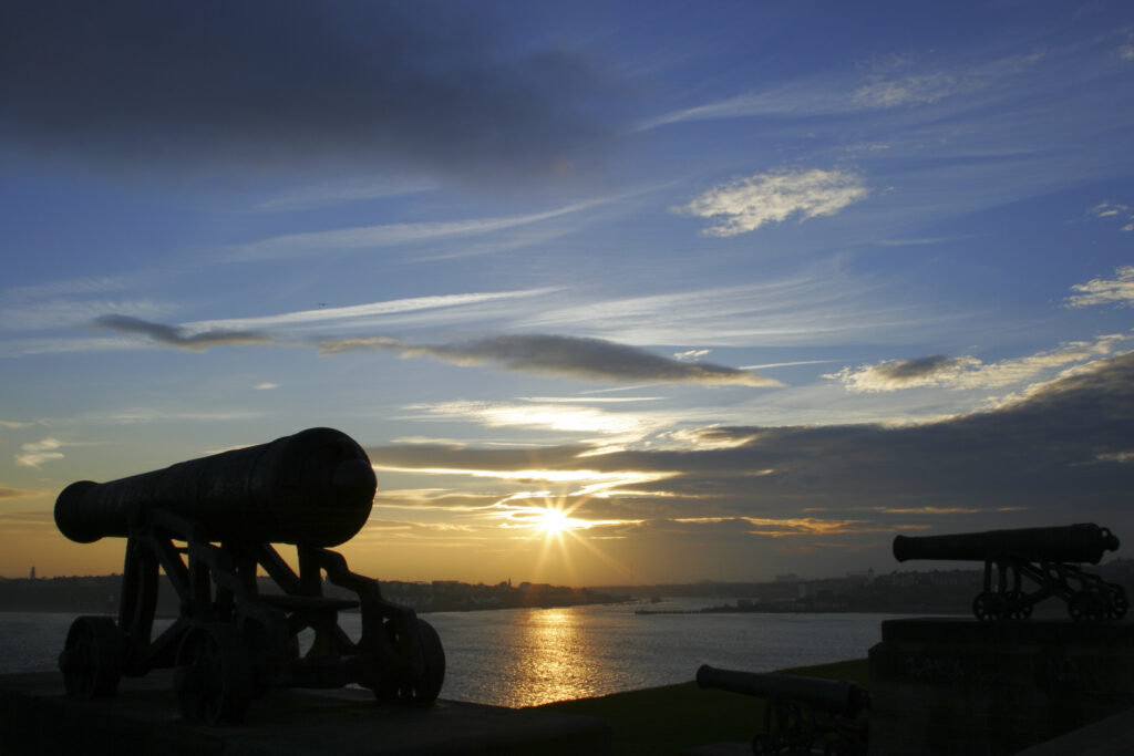 England, Tyne and wear, Tynemouth. Sunset behind the river Tyne and the Collingwood Cannons