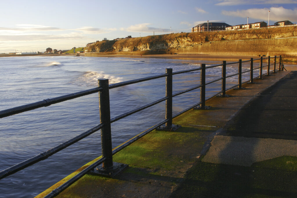 England, Tyne and Wear, Seaburn. Early morning view looking along the promenade towards Roker Rocks and the North Sea