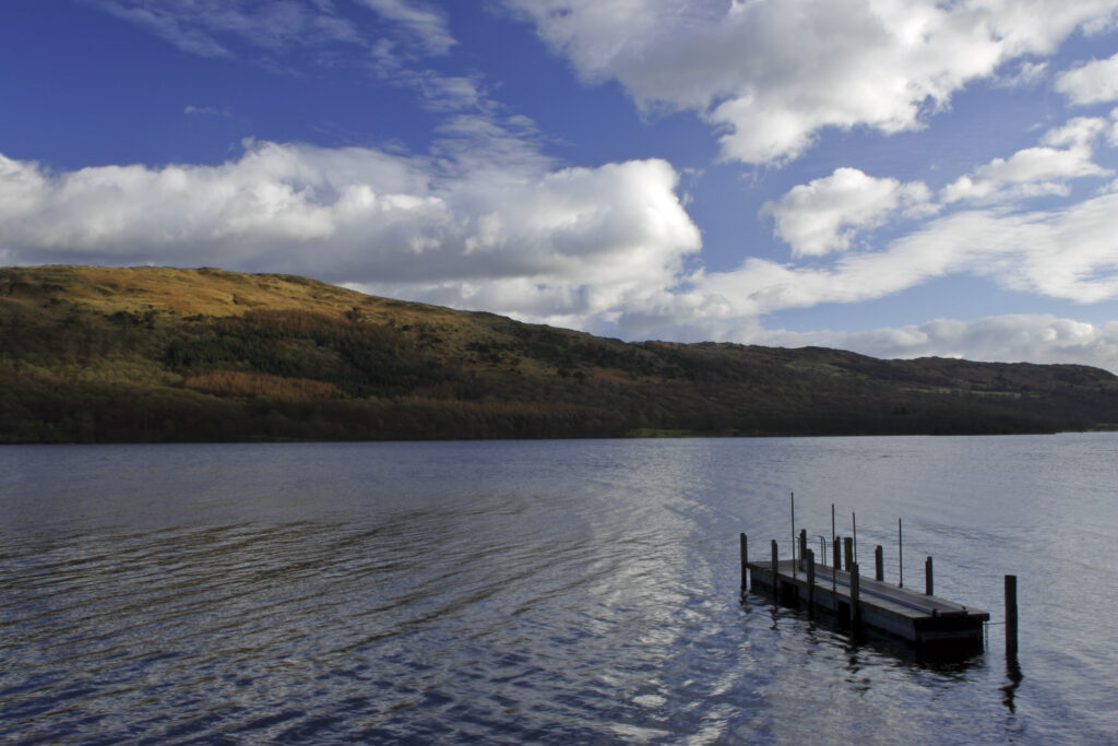 ENGLAND, Cumbria, Lake District National Park. Afternoon light illuminates the features of Coniston Water on the Cumbria Way