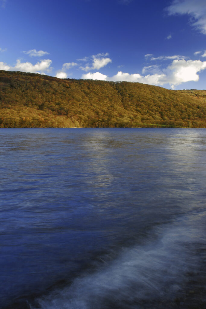 ENGLAND, Cumbria, Lake District National Park. Afternoon light illuminates the features of Coniston Water on the Cumbria Way