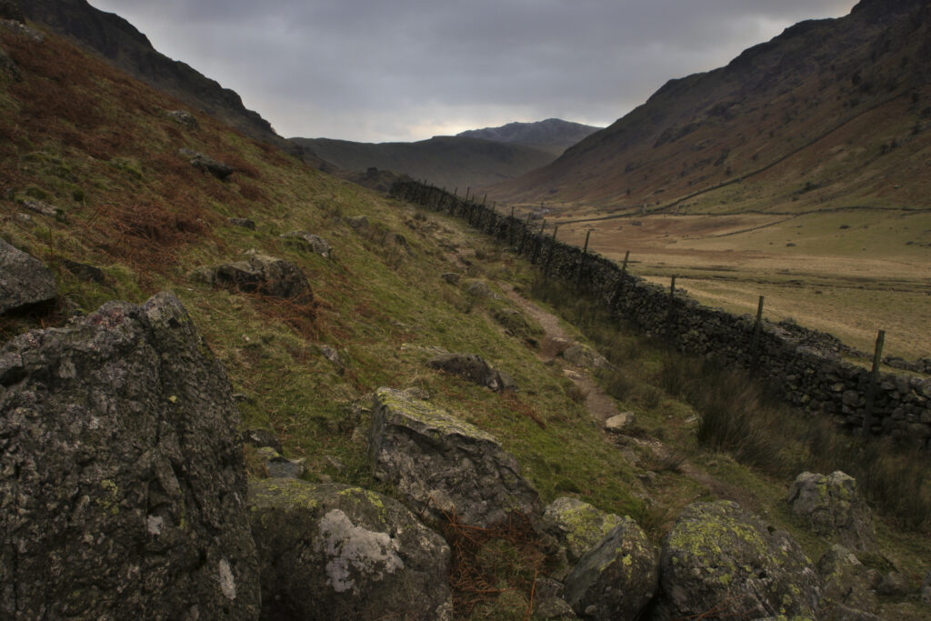 ENGLAND, Cumbria, Lake District National Park. Storm clouds dominate thewild landscape of the Langstrath valley