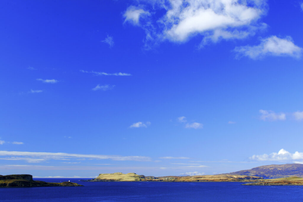 Scotland The Isle of Skye Loch Harport The deep hues of a blue sky reflected in the waters of Loch Harport