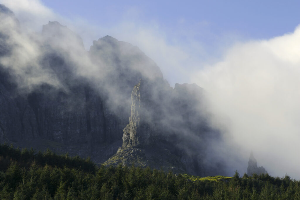 Scotland, The Isle of Skye, The Storr. Clouds gather around the old man of Storr and the backdrop of the Storr rock formation