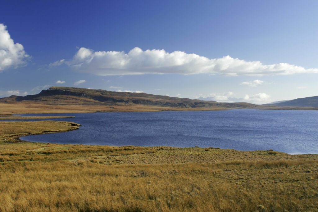 Scotland The Isle of Skye Loch Leathan Soft afternoon light illuminates Loch Leathan and surrounding moorland and hills