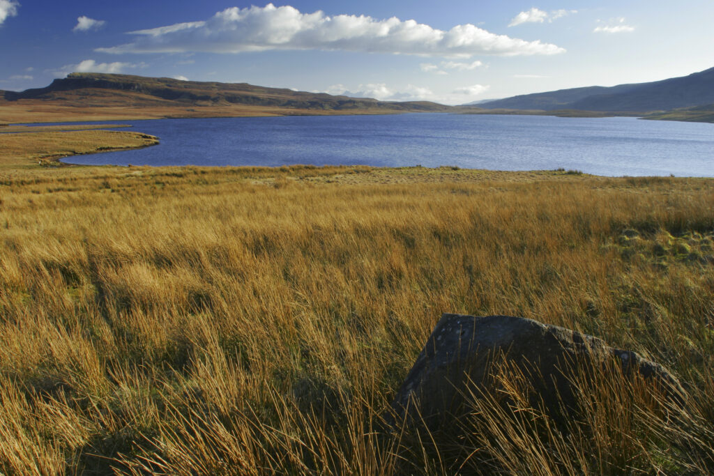 Scotland The Isle of Skye Loch Leathan Soft afternoon light illuminates Loch Leathan and surrounding moorland and hills