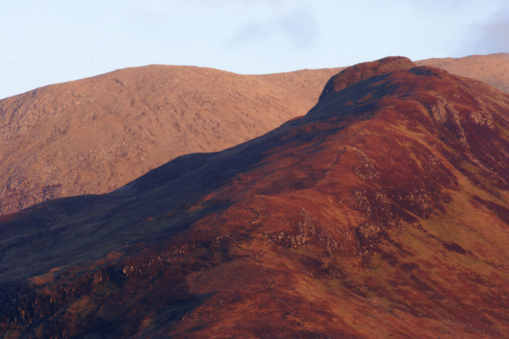 Scotland Isle of Skye Glen Sligachan Evening light iluminates the red hues of the wild mountain landscape of Glen Sligachan
