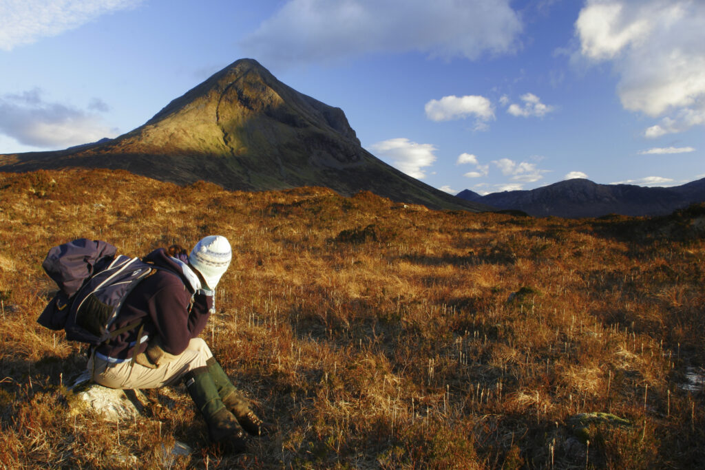 Scotland Isle of Skye Glen Sligachan A girl hikers takes a rest in the mountain landscape of Glen Sligachan