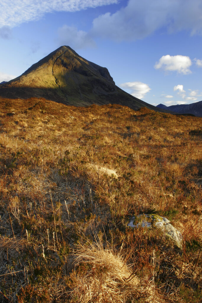 Scotland, Isle of Skye, Glen Sligachan. Evening light iluminates the red hues of the wild mountain landscape of Glen Sligachan