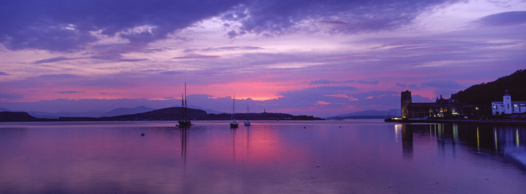 SCOTLAND, Scottish Highlands, Oban. The pinks and reds of a west coast sunset, looking towards the western isles and northern Oban.