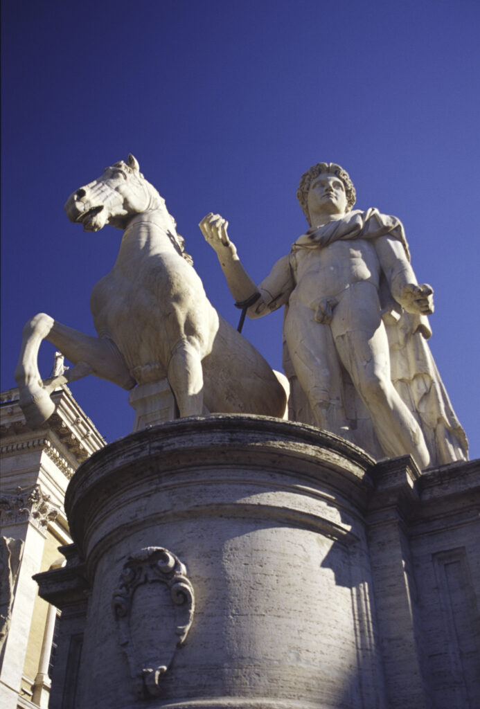 Italy, Lazio, Rome. Campidoglio Castor and Pollux statue in the city of Rome, against a blue sky backdrop.