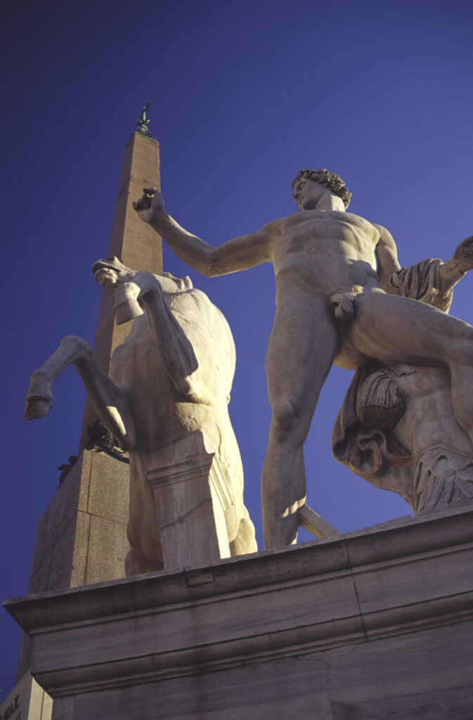 Italy, Lazio, Rome. Sculpture of naked figure and his rearing horse beside the Palazzo del Quirinale home of the president of Italy.