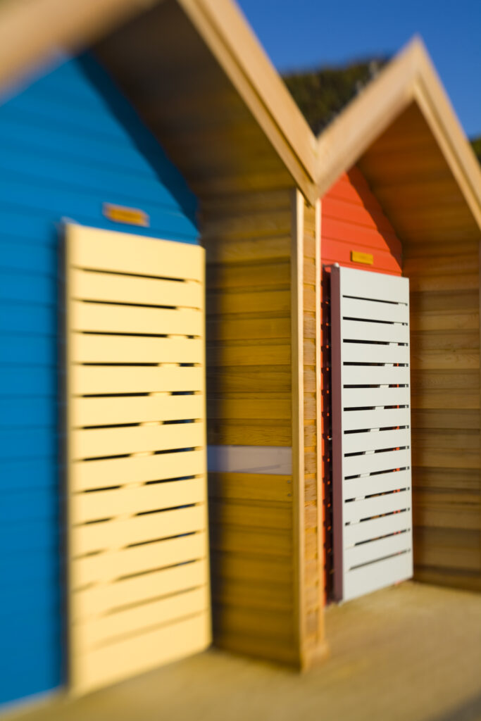 England, Northumberland, Blyth. New colourful beach huts on the promenade at Blyth Beach.