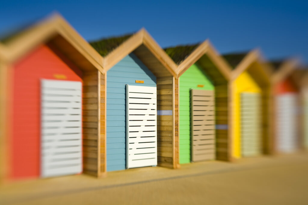 England, Northumberland, Blyth. New colourful beach huts on the promenade at Blyth Beach.