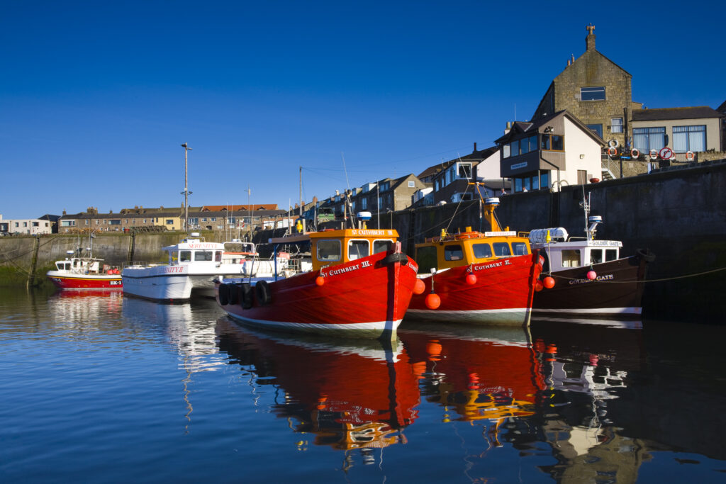 England, Northumberland, Seahouses. Boats moored in the harbour at Seahouses, known as 'The Gateway to the Farne Islands'.
