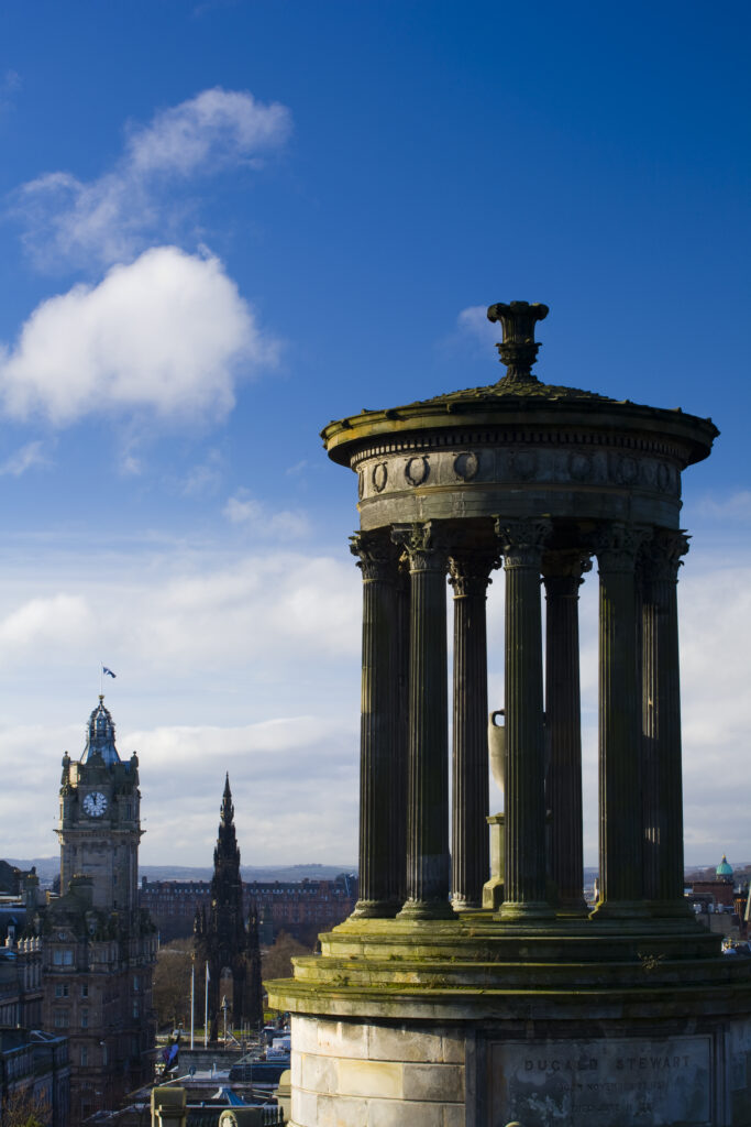 Scotland, Edinburgh, Calton Hill. The Dugald Stewart Monument on Calton Hill, looking towards the Castle and Old Town of Edinburgh.