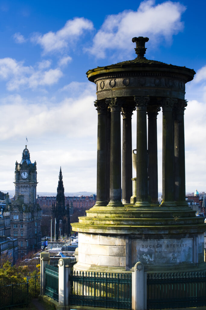 Scotland, Edinburgh, Calton Hill. The Dugald Stewart Monument on Calton Hill, looking towards the Castle and Old Town of Edinburgh.
