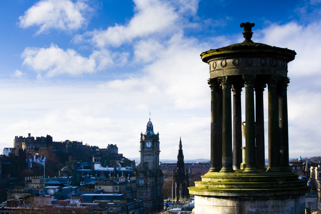 Scotland, Edinburgh, Calton Hill. The Dugald Stewart Monument on Calton Hill, looking towards the Castle and Old Town of Edinburgh.