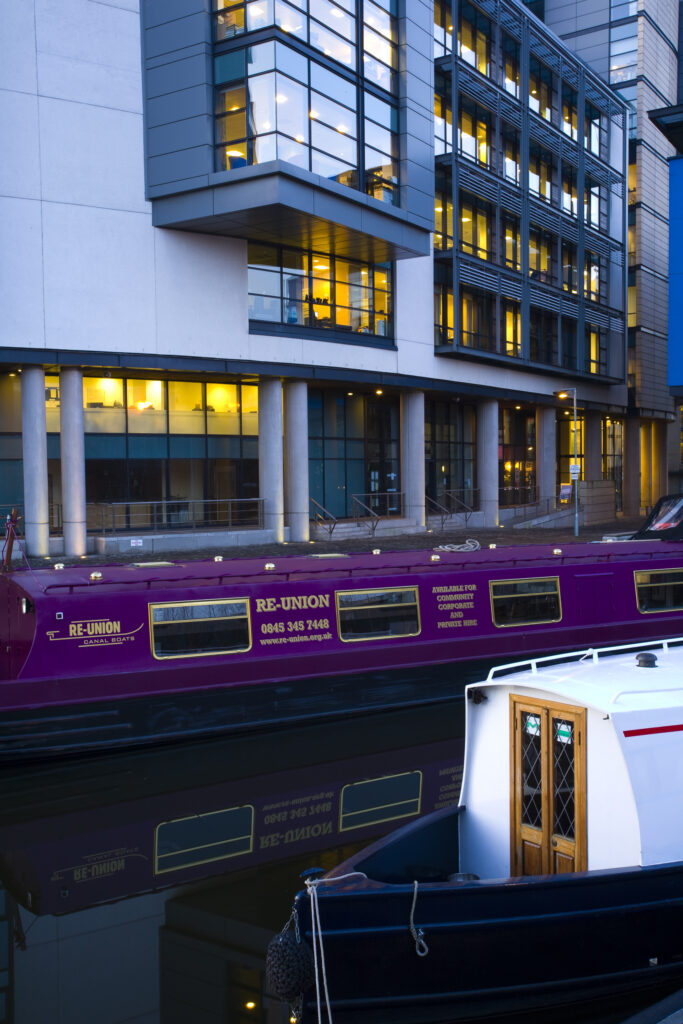 Scotland, Edinburgh, Fountainbridge. Canal Boats moored in the Lochrin Basin near Fountainbridge. Now known as the Edinburgh Quay, the site has seen recent redevelopment and a number of bars and apartments are situated along the quayside.