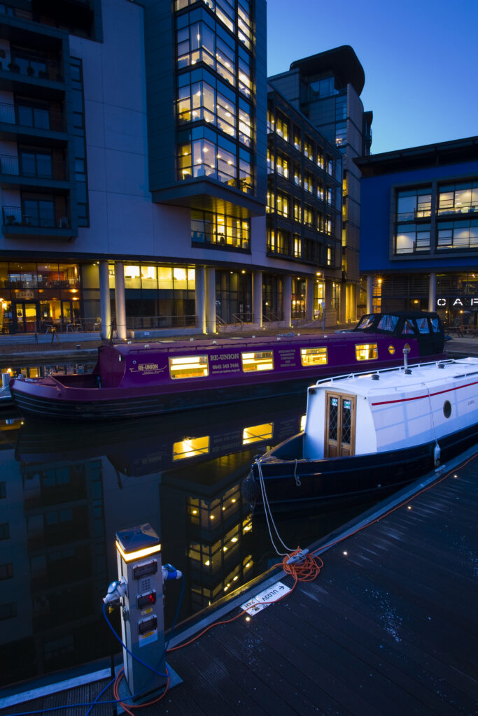 Scotland, Edinburgh, Fountainbridge. Canal Boats moored in the Lochrin Basin near Fountainbridge. Now known as the Edinburgh Quay, the site has seen recent redevelopment and a number of bars and apartments are situated along the quayside.