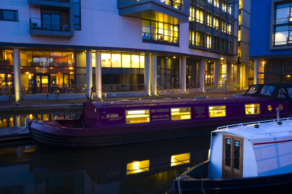 Scotland, Edinburgh, Fountainbridge. Canal Boats moored in the Lochrin Basin near Fountainbridge. Now known as the Edinburgh Quay, the site has seen recent redevelopment and a number of bars and apartments are situated along the quayside.
