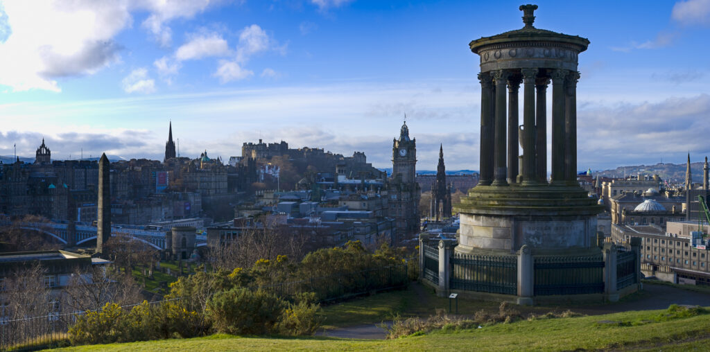 Scotland, Edinburgh, Calton Hill. The Dugald Stewart Monument on Calton Hill, looking towards the Castle and Old Town of Edinburgh.