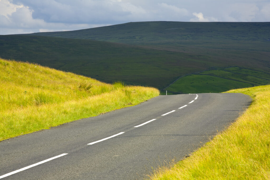 England, Northumberland, North Pennines. Country road running through dramatic Pennine scenery, in the North Pennines Area of Outstanding Beauty.