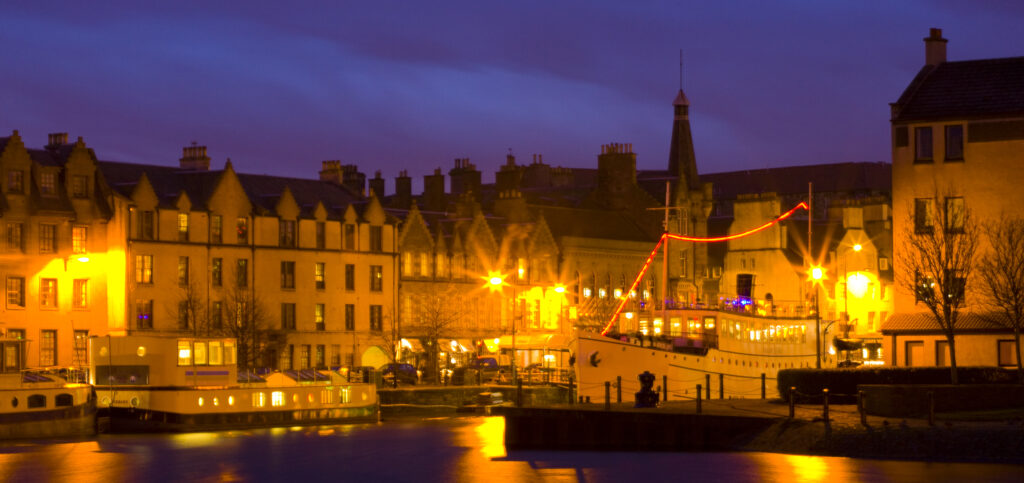Scotland, Edinburgh, Leith. Mary of Guise barge and the Ocean Mist boat, now a floating restaurant, on the shore in Leith.