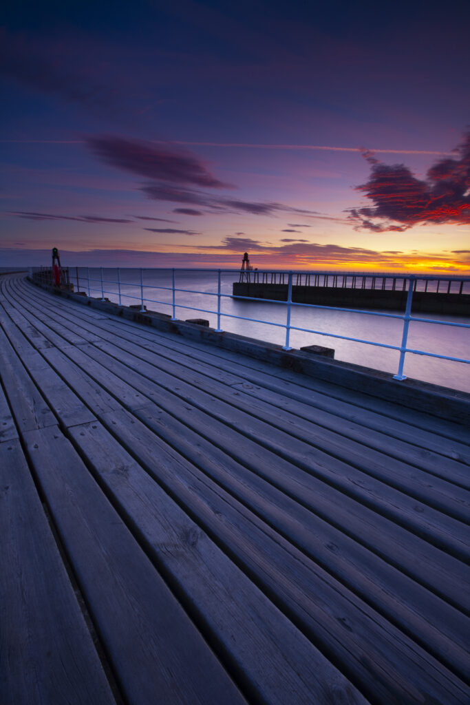 England, North Yorkshire, Whitby. The entrance piers of Whitby Harbour at dawn.