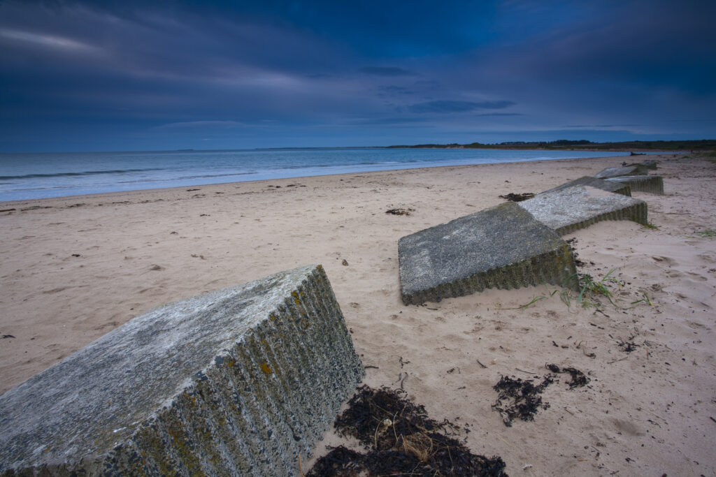 England, Northumberland, Alnmouth. Second World War coastal defences on the sandy beach at Alnmouth.