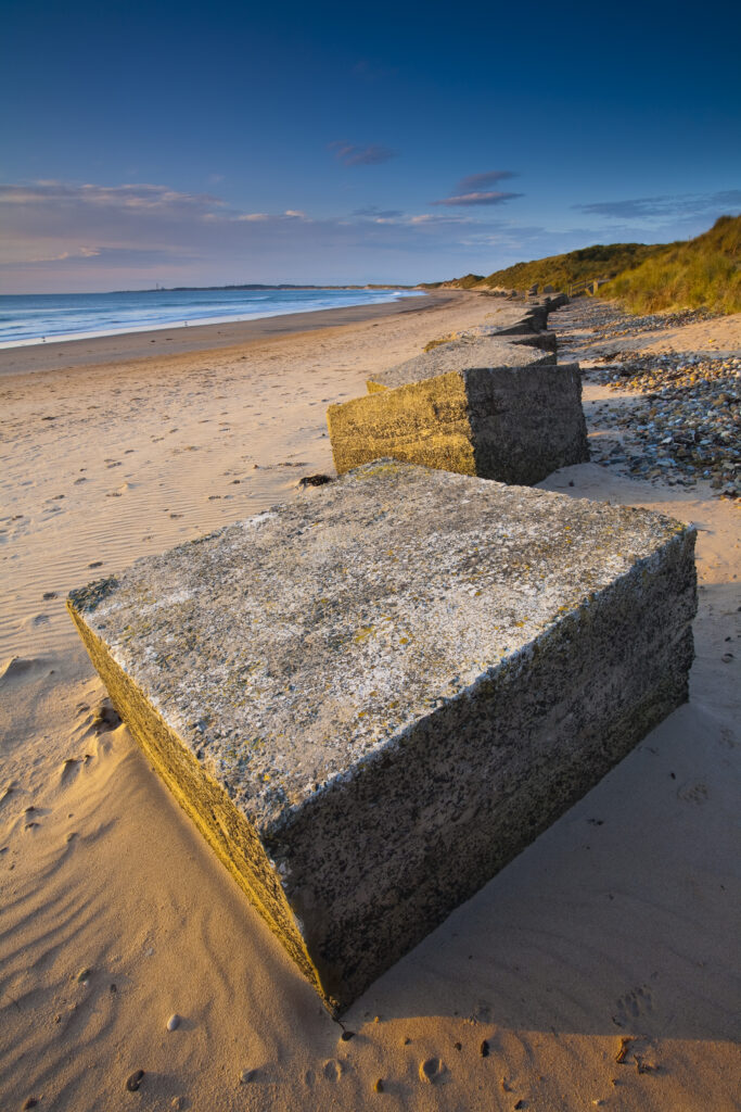 England, Northumberland, Druridge Bay. World War Two anti-tank blocks defending the picturesque beach at Druridge Bay.