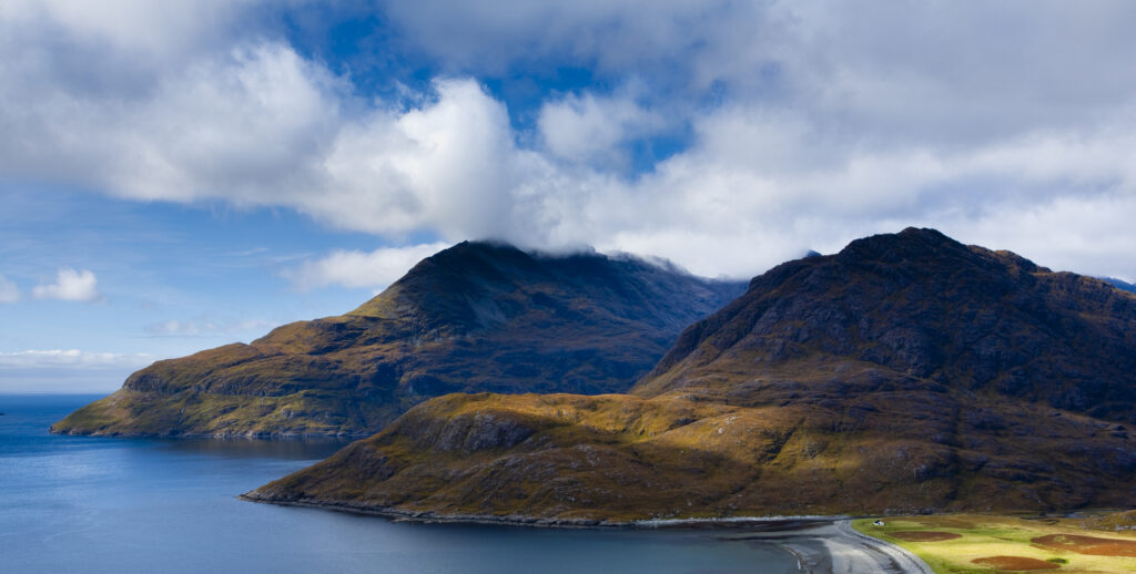 Scotland, Isle of Skye, Loch Scavaig. Breaking light on the lower hills of the Cuillin range and Loch Scavaig.