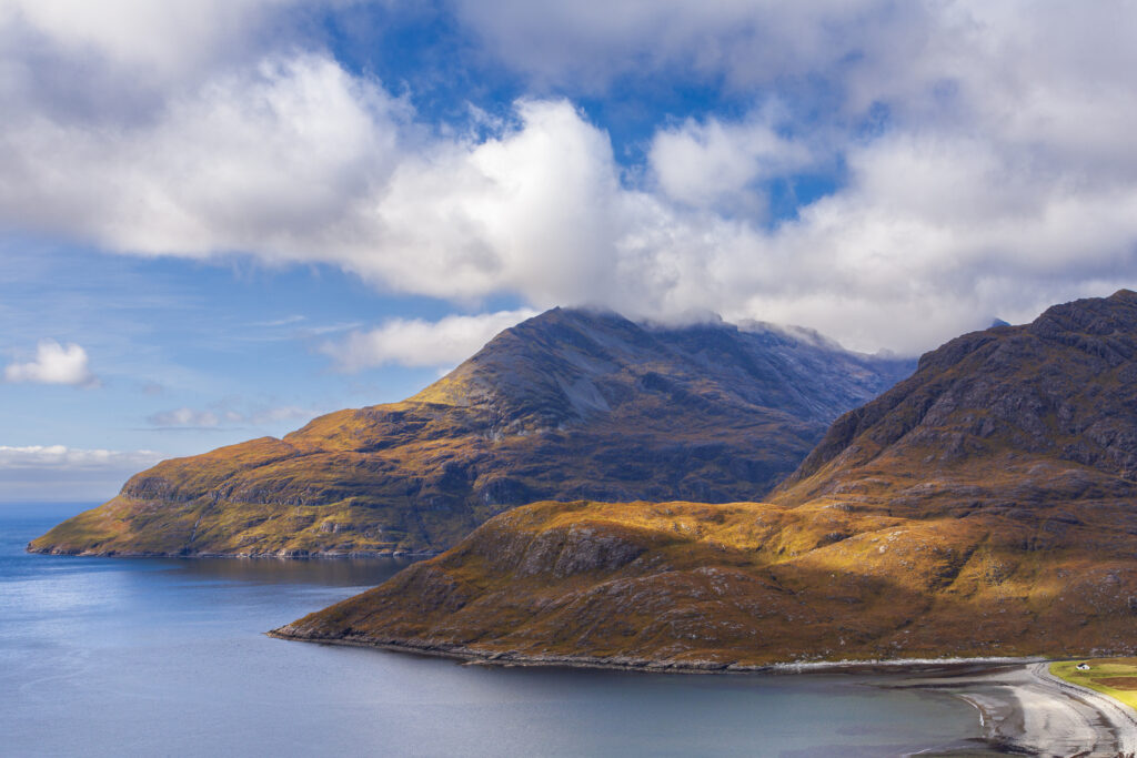 Scotland, Isle of Skye, Loch Scavaig. Breaking light on the lower hills of the Cuillin range and Loch Scavaig.