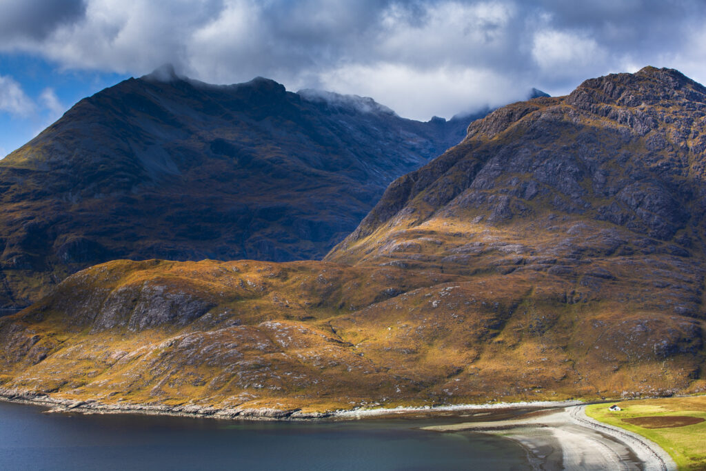 Scotland, Isle of Skye, Loch Scavaig. Breaking light on the lower hills of the Cuillin range and Loch Scavaig.