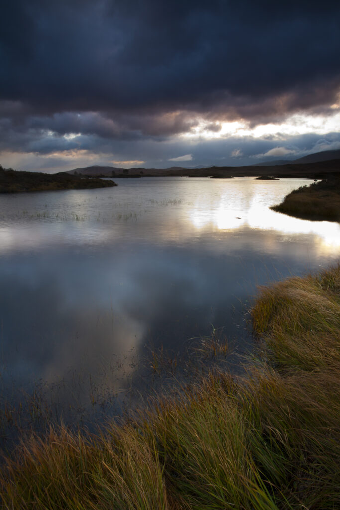 Scotland, Scottish Highlands, Rannoch Moor. Early morning sun on Loch Ba located on Rannoch Moor.