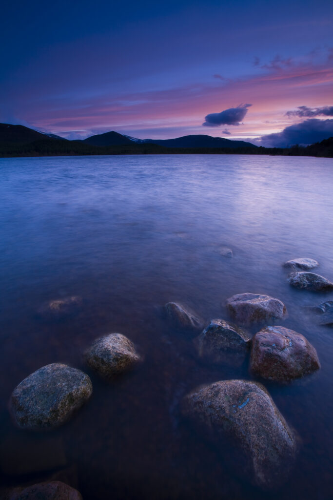 Scotland, Scottish Highlands, Cairngorms National Park. Deep red clouds above Loch Morlich and the surrounding mountains.
