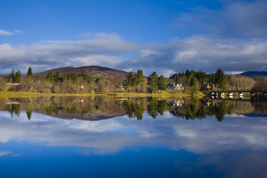 Scotland, Scottish Highlands, Cairngorms National Park. Mirror like reflections upon Loch Insh near Kincraig.