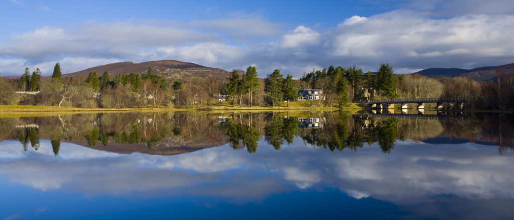 Scotland, Scottish Highlands, Cairngorms National Park. Mirror like reflections upon Loch Insh near Kincraig.