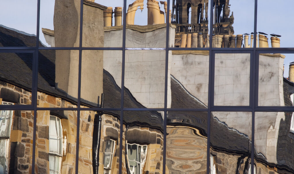 Scotland, Edinburgh, Edinburgh City. Traditional buidlings reflected in the windows of modern architecture.