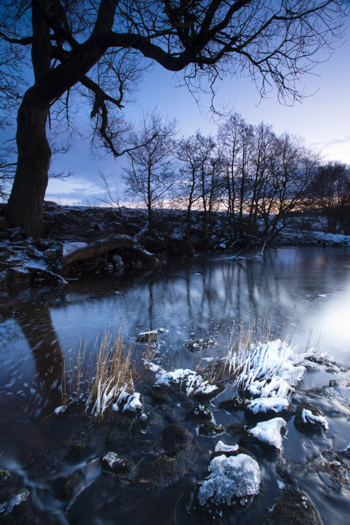England, Northumberland, Northumberland National Park. The River Rede near the village of Otterburn, photographed at dusk on a mid winter day.