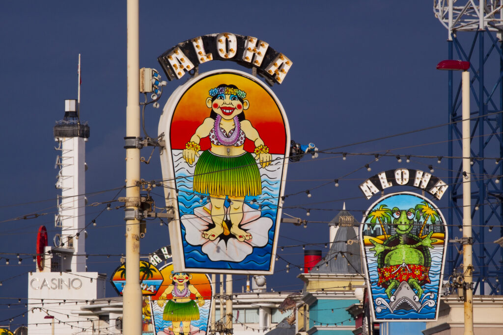 England, Lancashire, Blackpool. 'Aloha' signs on the Golden Mile near the Blackpool Pleasure Beach.