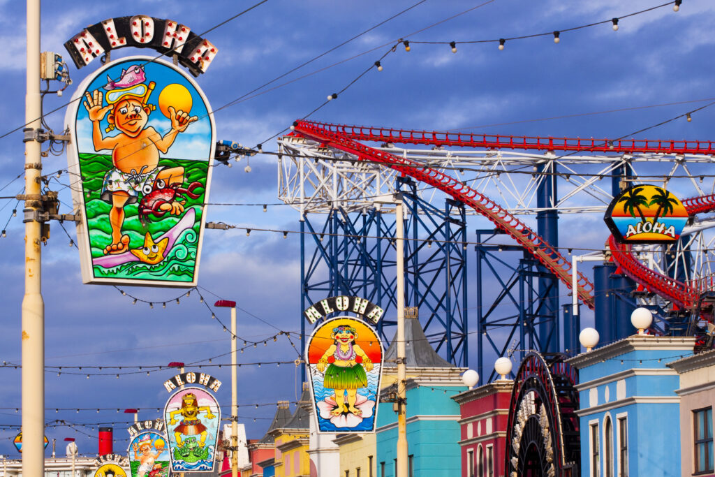 England, Lancashire, Blackpool. 'Aloha' signs on the Golden Mile near the Blackpool Pleasure Beach.