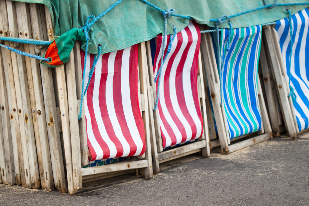 England, Lancashire, Blackpool. Beach Deck Chairs stacked on the Blackpool Golden Mile.