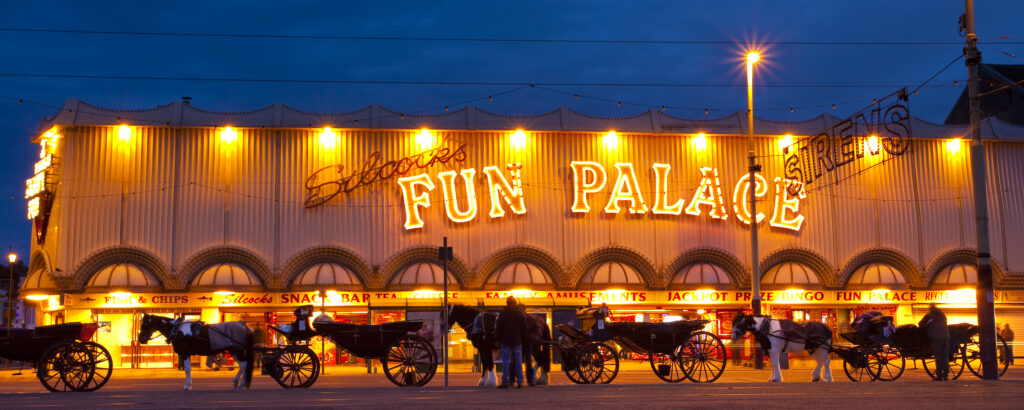 England, Lancashire, Blackpool. Hackney Carriages outside the Fun Palace amusement arcade on the Golden Mile.